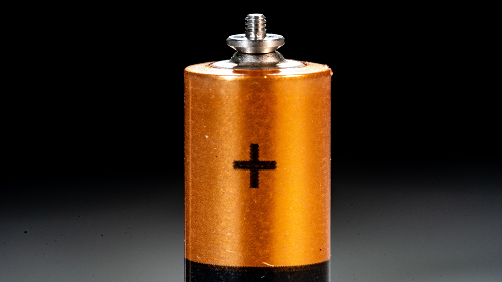 Micro Machine screw fastener on top of AA battery