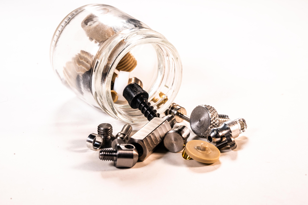micro machined parts spilling out of jar